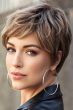 Woman in a light brown lace front pixie wig with choppy layers