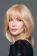 Woman in a warm blonde wiglet hair topper on the crown area