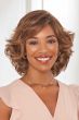 Black woman in a shoulder length layered lace front wig with side bangs