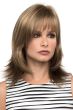Woman in a shoulder length dark ash blonde wig with feathered layers and arched bangs