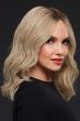 Woman in a past-the-shoulders, light ash blonde, wavy lace front wig