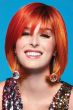 Woman in a chin length bright red and yellow bob wig with fringe bangs