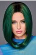 Woman in a past the shoulders angled straight emerald green wig