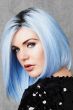 Woman in a past the shoulders pastel blue angled bob wig with dark roots
