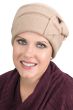Woman in beige wool beanie style cancer hat with side knot