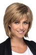 Woman in a shoulder length light auburn layered bob wig with fringe bangs