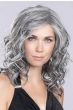 Woman in a past the shoulders salt and pepper curly lace front wig