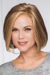 Woman in a short dark blonde blunt bob wig with curled under ends