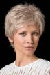Woman in a tousled light blonde short pixie wig with fringe bangs