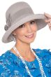 Woman in brimmed dressy grey summer hat with detailed side flower and bow