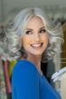 Woman in a shoulder length light grey lace front wig with barrel curls