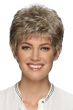 Woman in a short tousled ash blonde pixie wig with fringe bangs