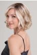 Woman in a chin length platinum blonde wavy wig