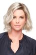 Woman in a chin length platinum blonde wavy wig