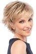 Woman in spiky blonde pixie cut wig with longer layers along the top and wispy side swept bangs