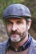 Cool older man in grey tweed wool driver cap or flat hat