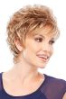 Woman in a curly auburn highlighted pixie wig with side swept bangs