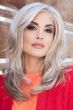 Woman in a past the shoulders light blonde wavy lace front wig with layers and side bangs