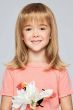 Little girl in a past the shoulders straight blonde wig with bangs