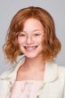Young girl in a past the chin wavy medium red lace front children's wig