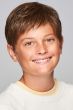 Young boy in a short layered medium brown children's wig