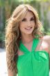 Woman in an extra long light brown curly lace front wig