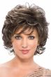 Woman in a short curly dark brown wig with wispy bangs