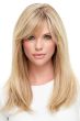 Woman in an extra long straight light blonde wig with side bangs