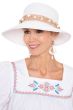 Woman in white summer straw vacation beach hat with raffia details and white bead accents