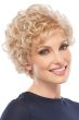 Woman in petite short curly blonde wig with bangs and layers for an older woman