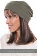 Woman in a long straight halo wig with bangs under an olive snood hat