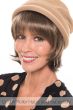 Woman in a medium chin length straight halo hair piece with bangs under a beige hat