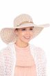 Woman in extra wide brimmed floppy woven beach or sun hat with shell accents