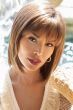 Woman in a medium auburn shoulder length blunt bob wig with fringe bangs