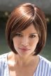 Woman in brown, short or chin length bob cut wig with long bangs