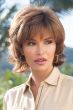 Woman in a chin length light auburn bob wig with layering throughout and fringe bangs