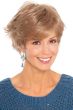 Woman in sassy, flippy, layered short blonde wig with bangs