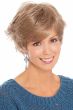 Woman in sassy, flippy, layered short blonde wig with bangs