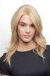 Woman in a human hair past the shoulders pale blonde with long layers and side bangs