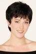 Woman in a large close cropped dark brown pixie wig with wispy bangs