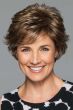 Woman in a petite medium brown short layered pixie bob wig with side fringe bangs