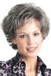 Woman in a petite short medium grey curly wig with short bangs