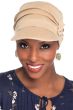 Woman in blue shirt wearing beige brimmed cancer hat with pleating