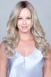 Woman in an extra long medium blonde curly lace front wig