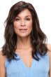 Woman in a past the shoulders dark brown wavy wig with long side bangs