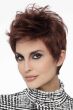 Woman in a tousled dark red pixie wig with longer layers on top
