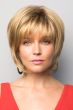 Woman in blonde short chin length bob wig with layers and bangs