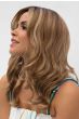 Woman in an extra long light auburn curly lace front wig