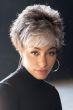 Woman in short spiky grey wig with layers and bangs
