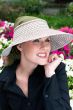 Woman outdoors in woven sun visor with scarf underneath